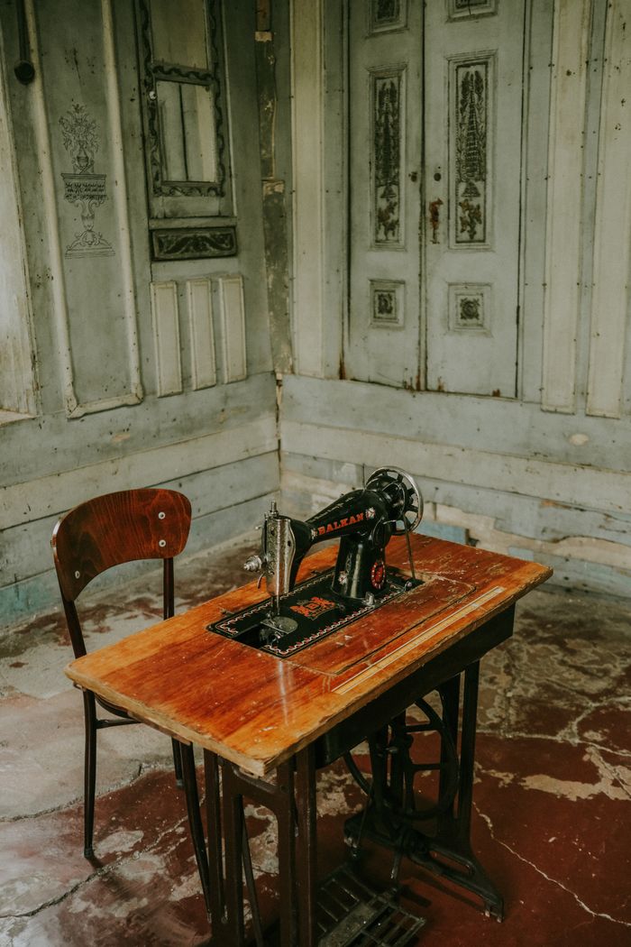 Mastering the First Impression: Your intriguing post title goes here A vintage sewing machine on a wooden table in a rustic, vintage-themed room, capturing an old-world charm.